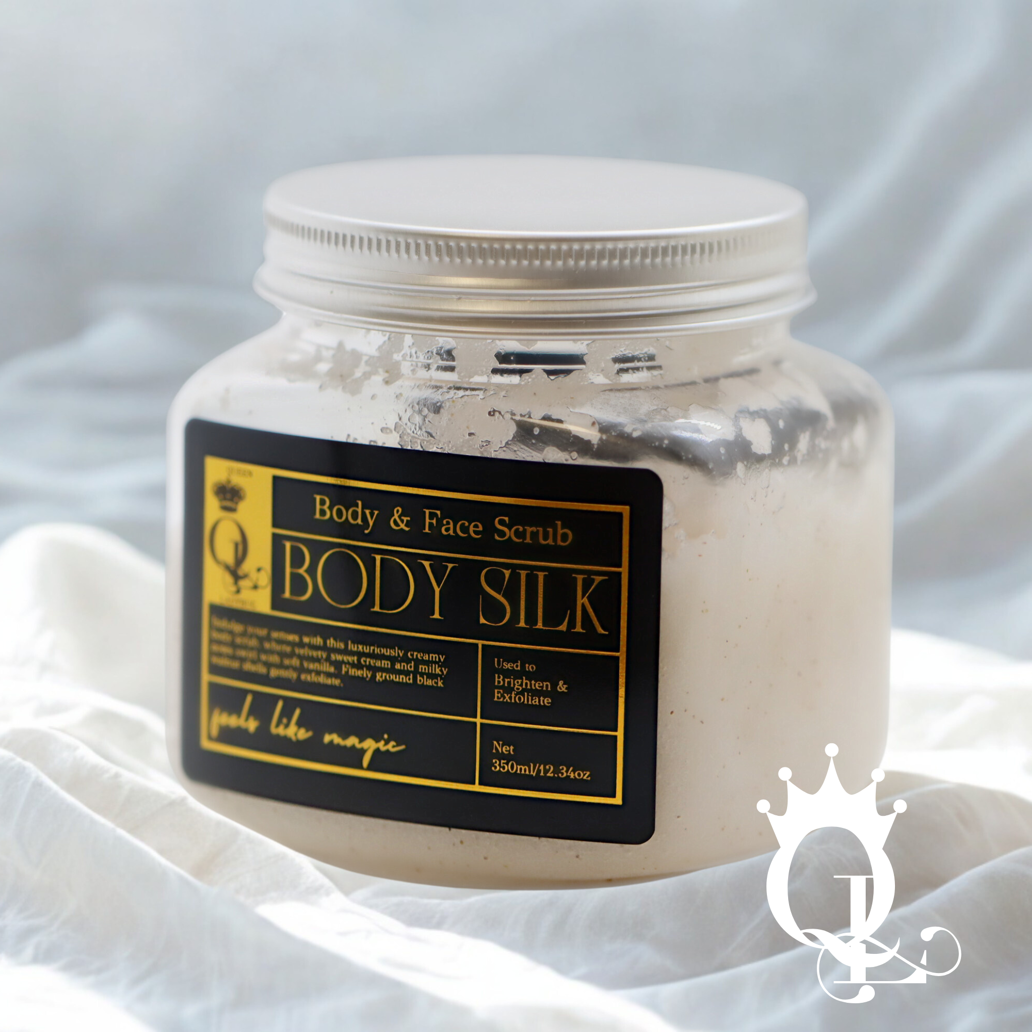 Jar of Body Silk body and face scrub with a label on a white fabric background